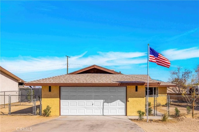 ranch-style home with roof with shingles, fence, a gate, and stucco siding