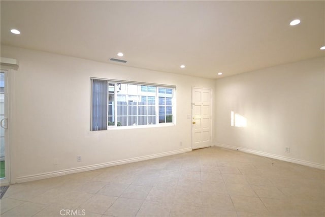 unfurnished room featuring recessed lighting, visible vents, and baseboards