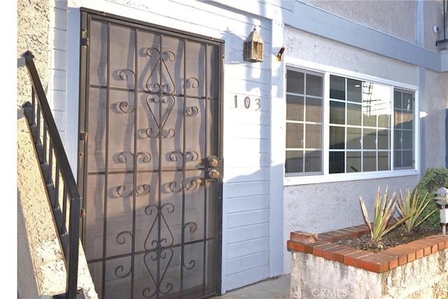 entrance to property with stucco siding
