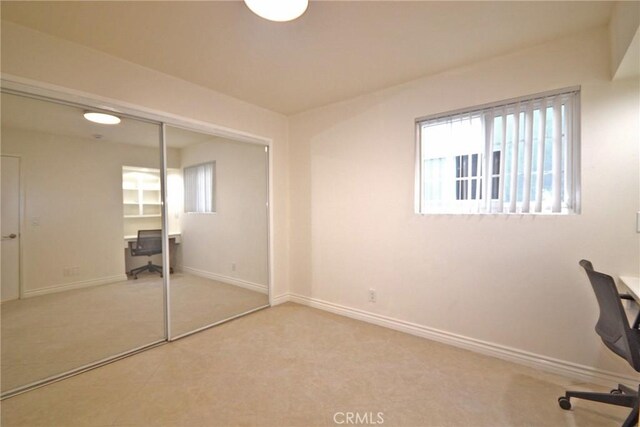 interior space featuring carpet floors and baseboards