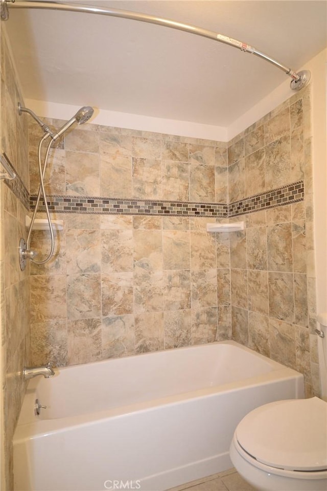 full bath with tile patterned flooring, toilet, and tub / shower combination