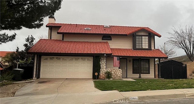 mediterranean / spanish home with concrete driveway, a front lawn, a chimney, and a tile roof