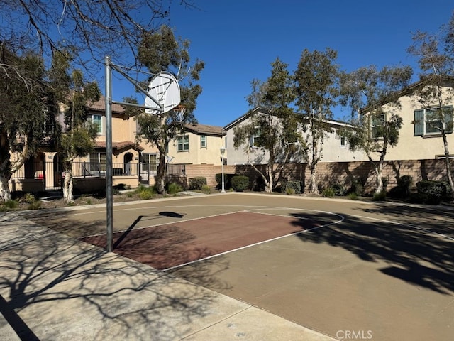 view of basketball court with community basketball court and fence