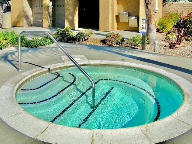 view of swimming pool with a community hot tub and a patio