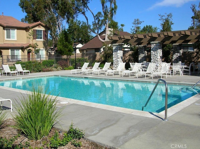 pool featuring a patio area, fence, and a pergola