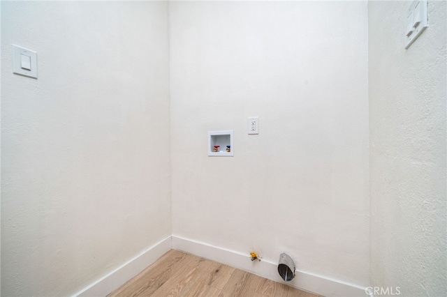 washroom featuring washer hookup, light wood finished floors, hookup for a gas dryer, laundry area, and baseboards