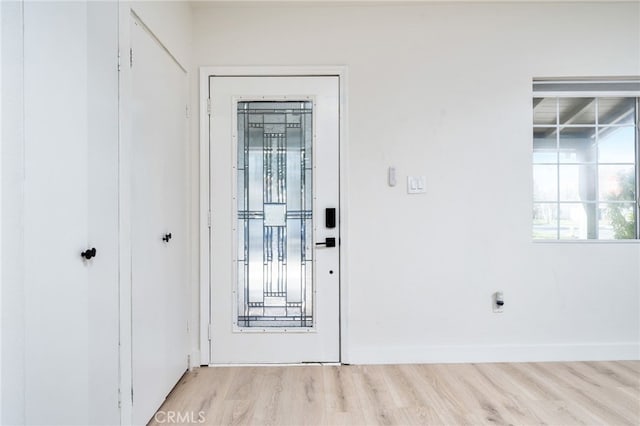 entrance foyer featuring wood finished floors and baseboards