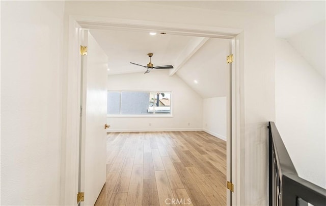 additional living space featuring lofted ceiling with beams, baseboards, light wood-style flooring, and a ceiling fan