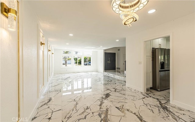 hall with recessed lighting, marble finish floor, and baseboards