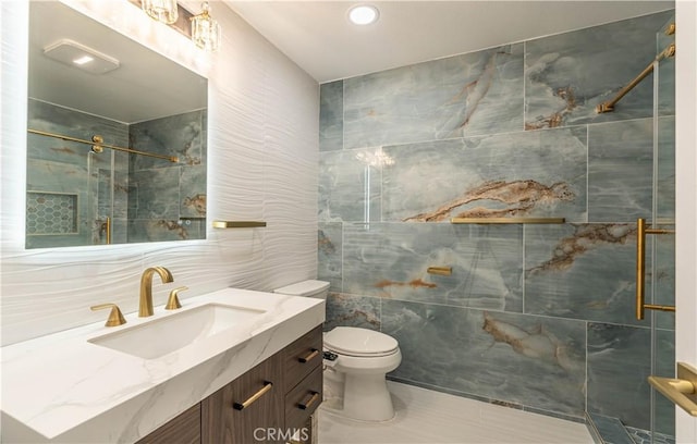 full bath featuring a stall shower, tile walls, toilet, and vanity