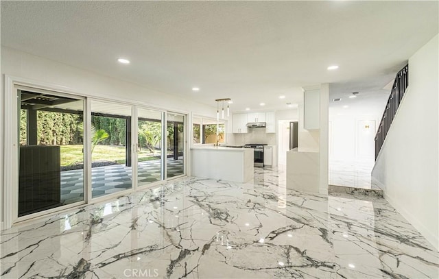 unfurnished living room featuring stairs, marble finish floor, baseboards, and recessed lighting