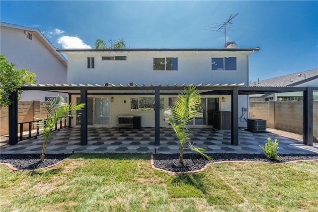 rear view of house featuring a patio, a yard, fence, and central air condition unit