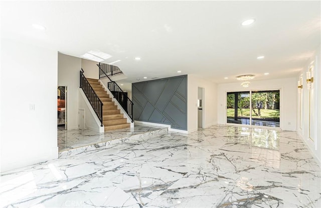 unfurnished living room featuring marble finish floor, stairs, and recessed lighting