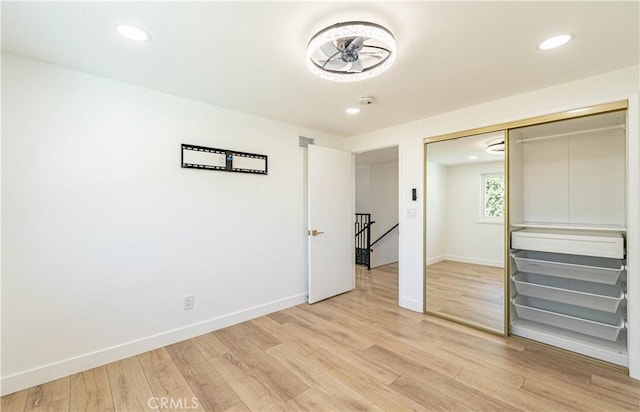 unfurnished bedroom with light wood-style flooring, baseboards, and recessed lighting