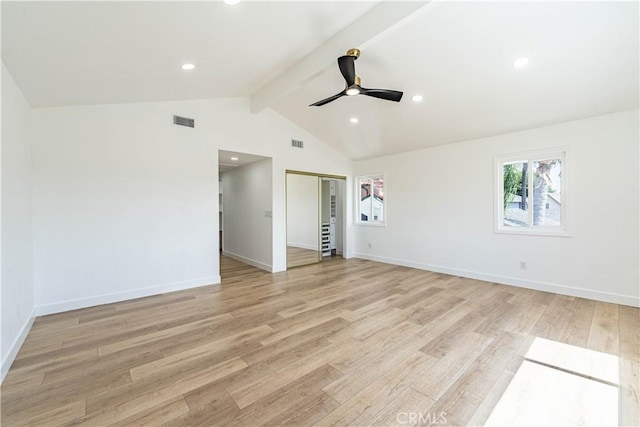 spare room with vaulted ceiling with beams, light wood-style floors, baseboards, and visible vents