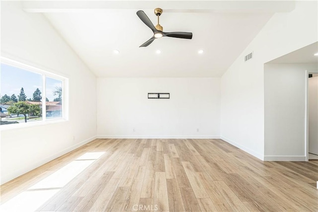 spare room with light wood-style flooring, visible vents, vaulted ceiling, and a ceiling fan