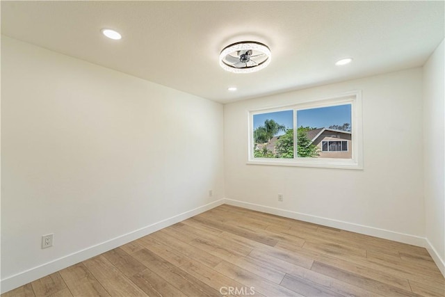 unfurnished room with recessed lighting, baseboards, and light wood finished floors