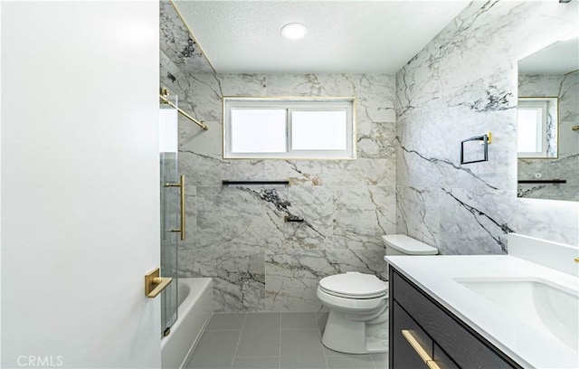 bathroom featuring washtub / shower combination, a wealth of natural light, vanity, and toilet