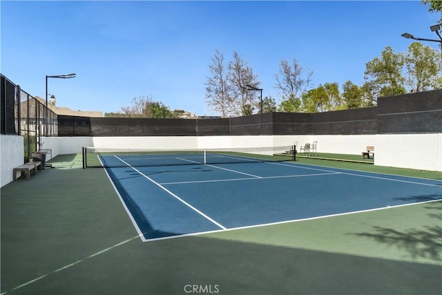 view of sport court with fence