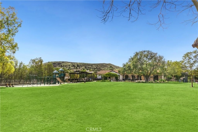 surrounding community featuring playground community and a lawn