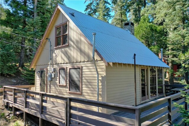 612 Rose Ln, Twin Peaks, CA 92391 - view of side of property with metal roof, a chimney, and a deck