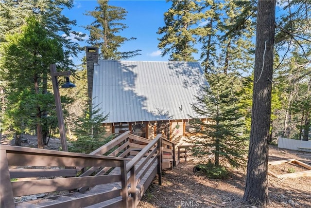 612 Rose Ln, Twin Peaks, CA 92391 - view of side of home with metal roof and a chimney