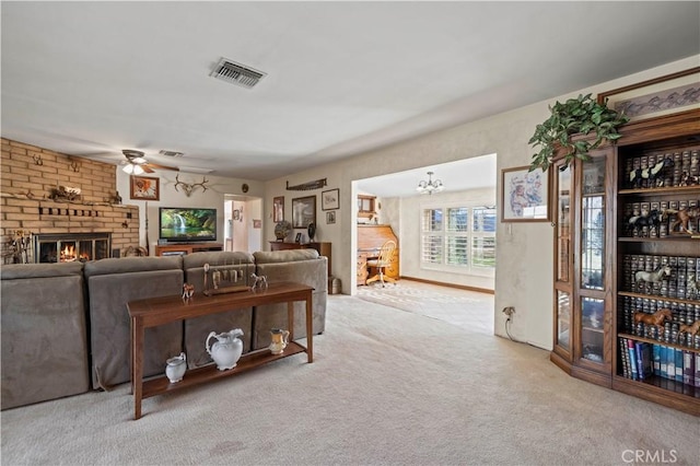 living area with a ceiling fan, carpet flooring, a fireplace, and visible vents