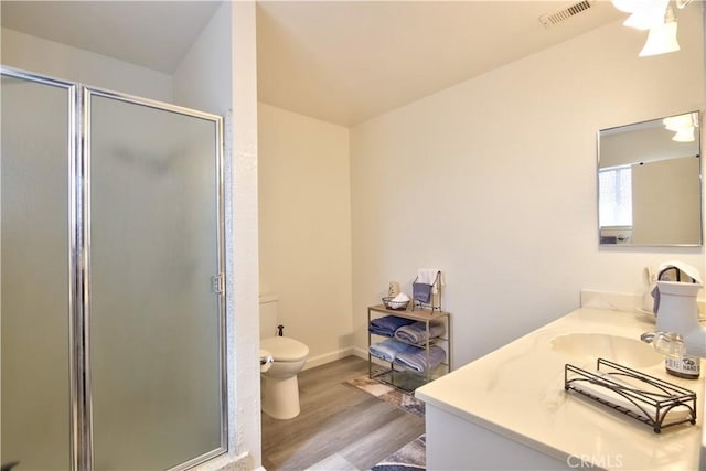 25602 Malaga Rd, Menifee, CA 92585 - full bath featuring wood finished floors, toilet, a stall shower, a ceiling fan, and vanity