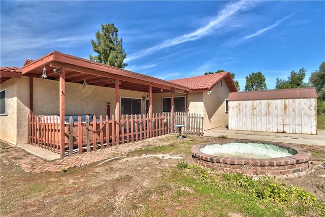 25602 Malaga Rd, Menifee, CA 92585 - back of house featuring stucco siding, fence, and a tiled roof