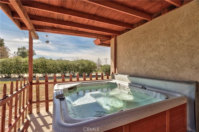 view of swimming pool with a hot tub