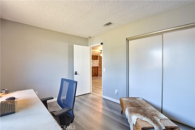 25602 Malaga Rd, Menifee, CA 92585 - home office with wood finished floors, baseboards, and a textured ceiling