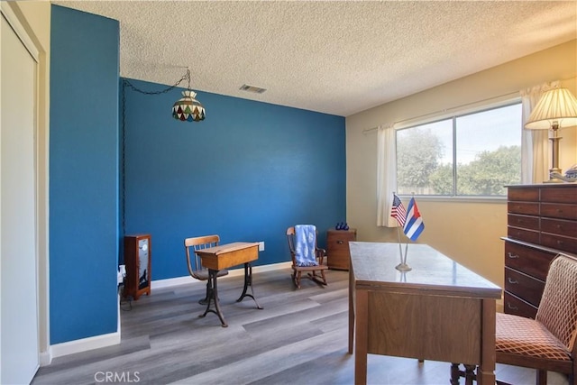 25602 Malaga Rd, Menifee, CA 92585 - home office featuring a textured ceiling, wood finished floors, baseboards, and a chandelier