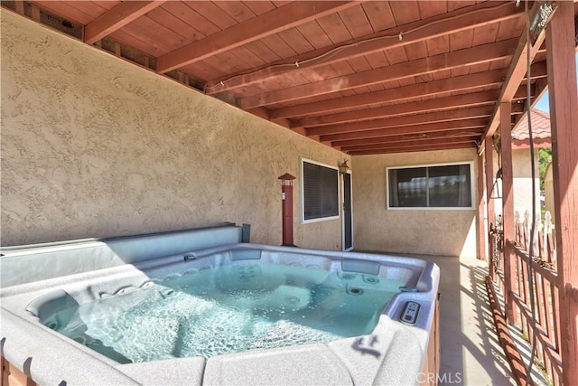 view of pool with a hot tub