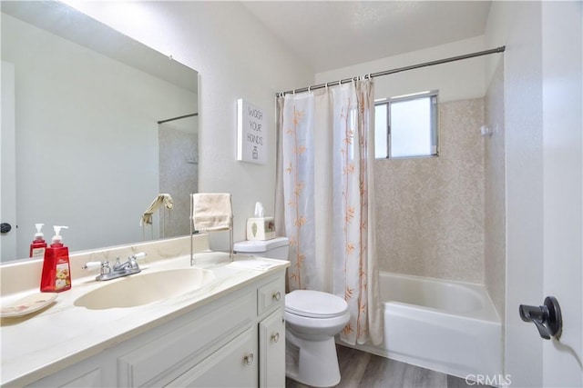 bathroom with toilet, wood finished floors, shower / tub combo with curtain, and vanity