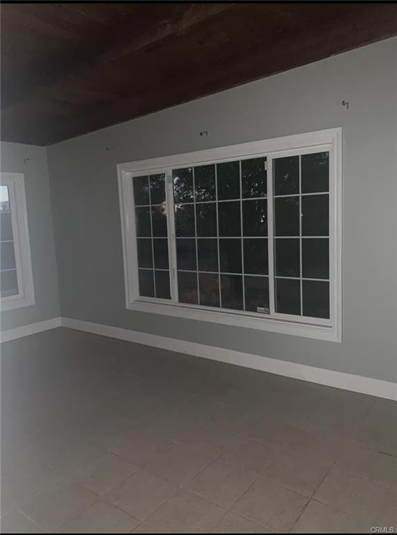 unfurnished room featuring baseboards