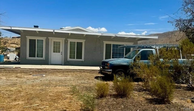 view of front of property featuring a patio area and stucco siding