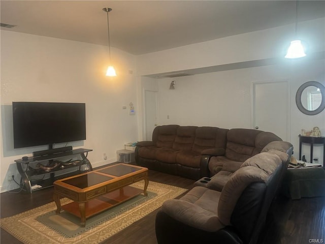 living area with visible vents and wood finished floors