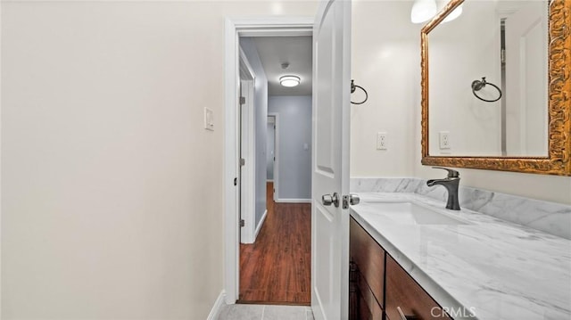 bathroom with vanity and baseboards