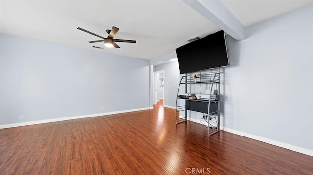 unfurnished living room featuring a ceiling fan, visible vents, baseboards, and wood finished floors