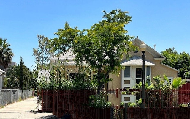 view of home's exterior with a fenced front yard and stucco siding