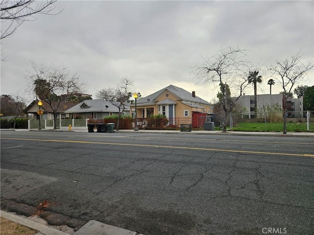 view of front of home featuring fence