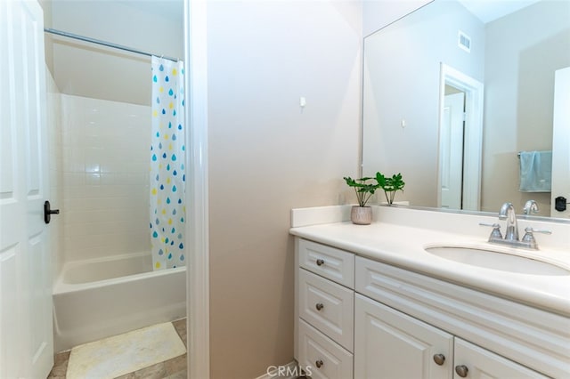 bathroom featuring visible vents, shower / bath combo with shower curtain, and vanity