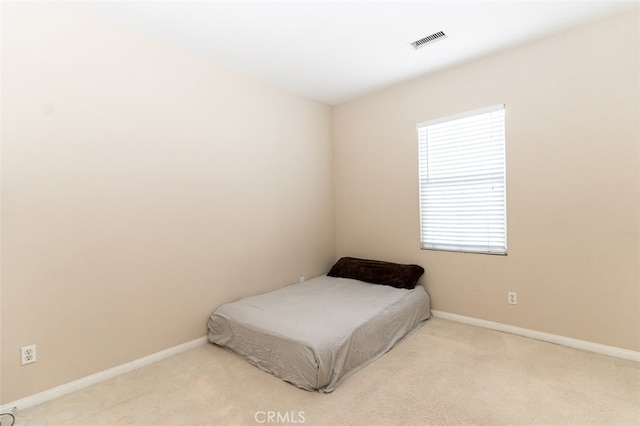 bedroom featuring baseboards, visible vents, and carpet flooring