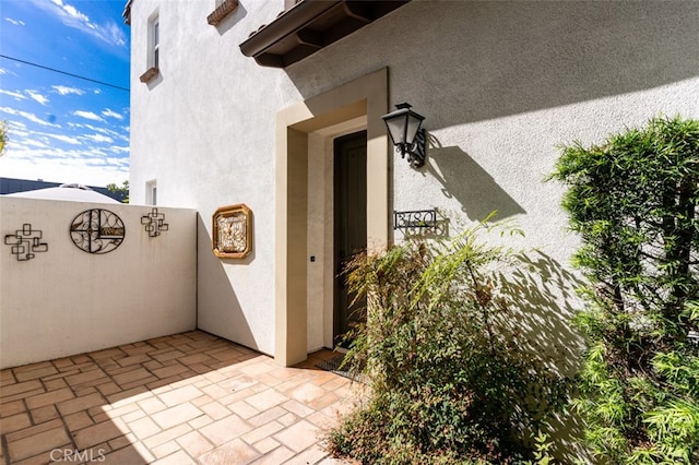 doorway to property with stucco siding