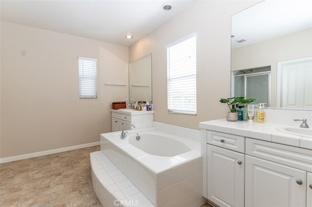 bathroom with visible vents, two vanities, a sink, a shower stall, and a bath