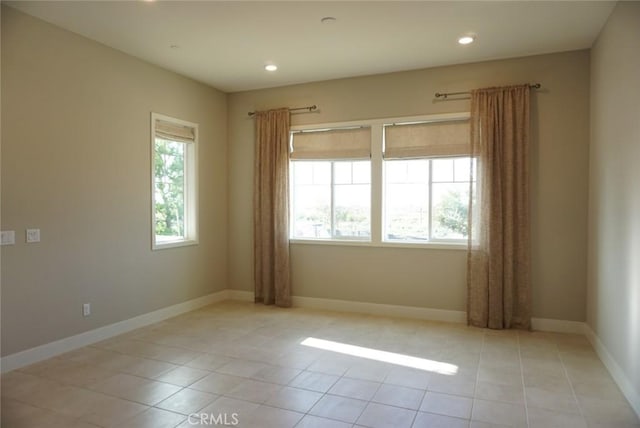 empty room with recessed lighting, light tile patterned flooring, and baseboards