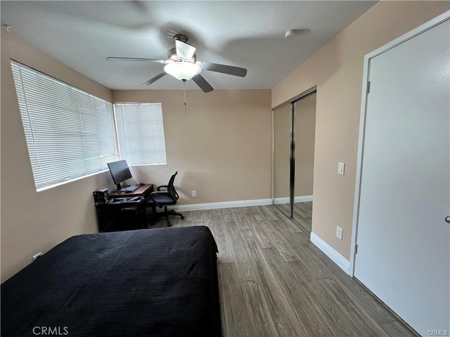 bedroom featuring ceiling fan, wood finished floors, and baseboards