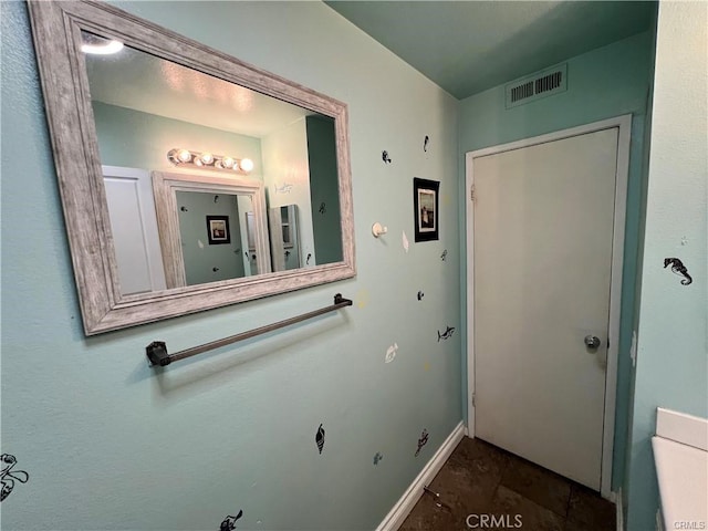 bathroom with baseboards and visible vents