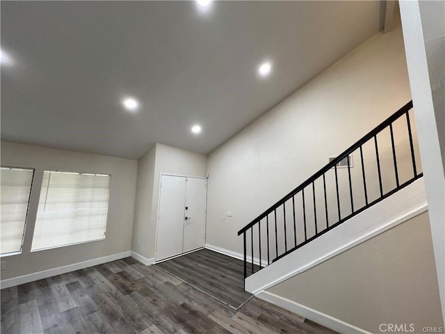 entrance foyer with baseboards, stairway, dark wood-style flooring, vaulted ceiling, and recessed lighting