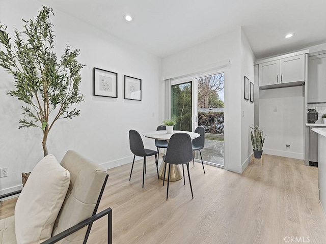 dining room with light wood-style flooring, baseboards, and recessed lighting